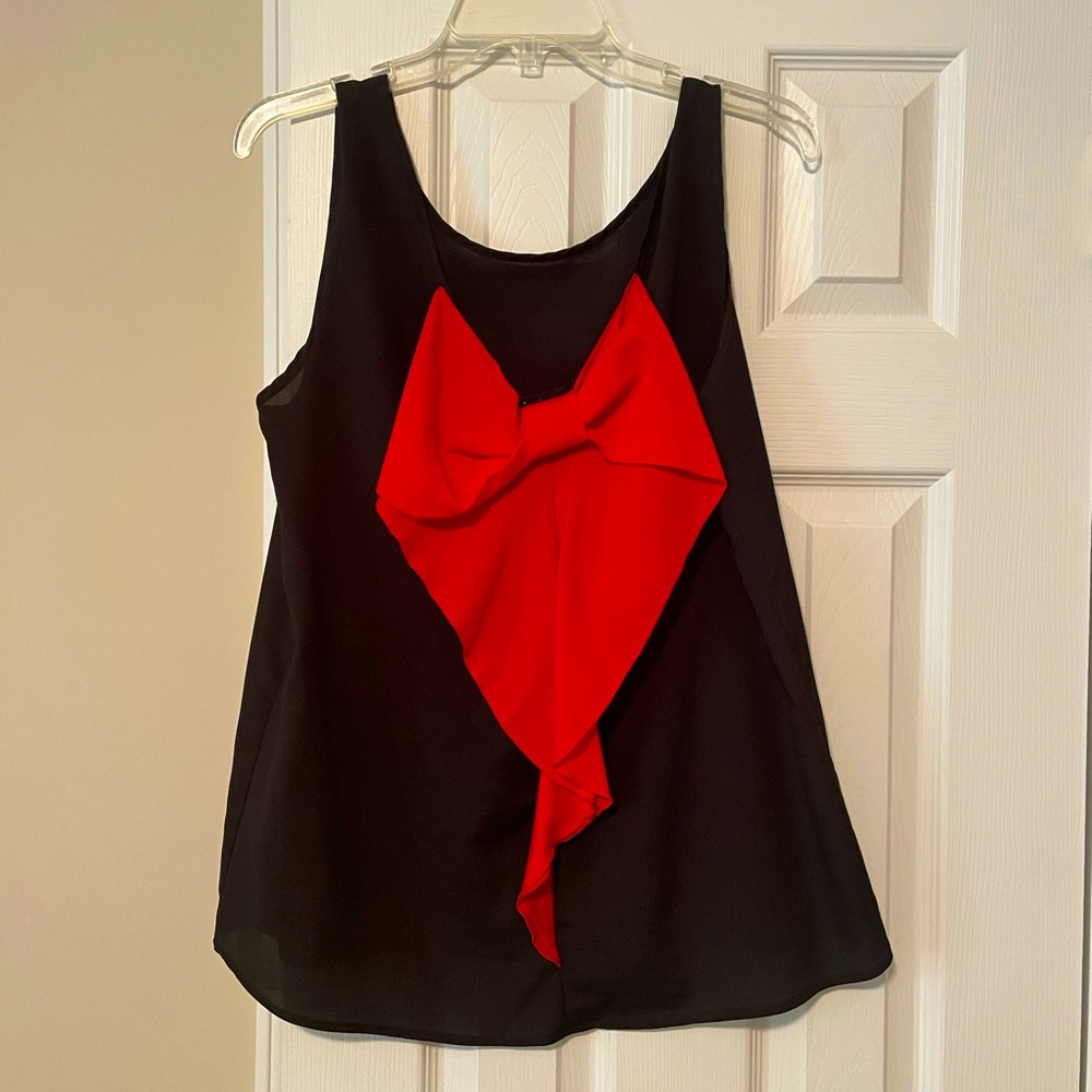 Cute black tank top with red bow on back. Size L.